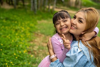 Parent carrying child with Down syndrome
