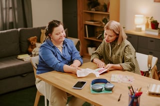 Mother and daughter with Down syndrome at home